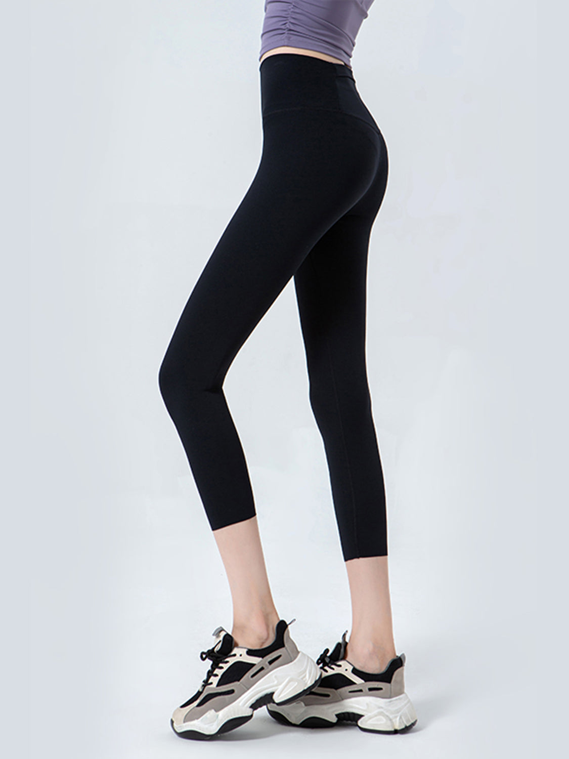 Black sculpted crop leggings with a high waistband and mesh detail.
