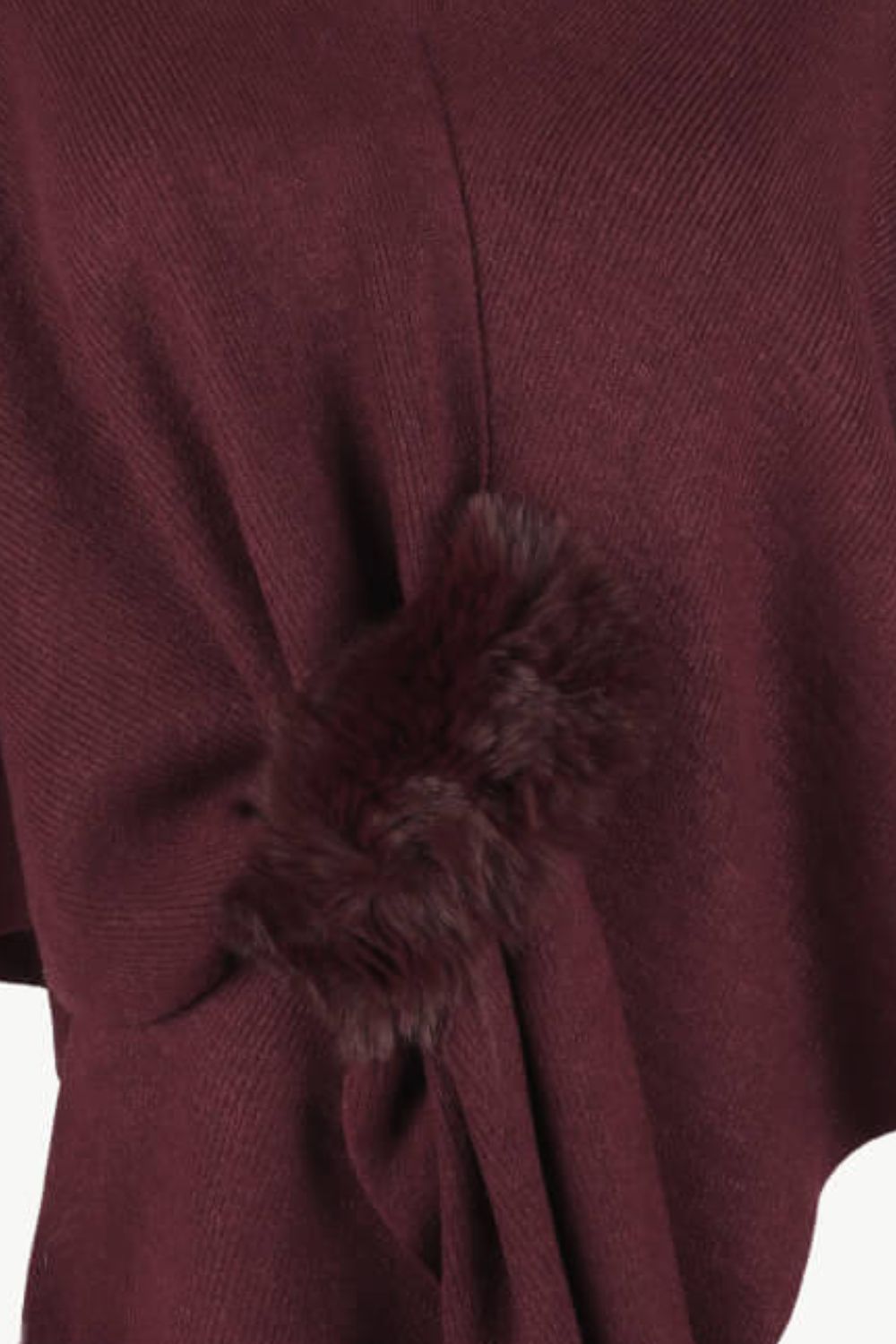 Wine knit cape with faux fur trim detail.