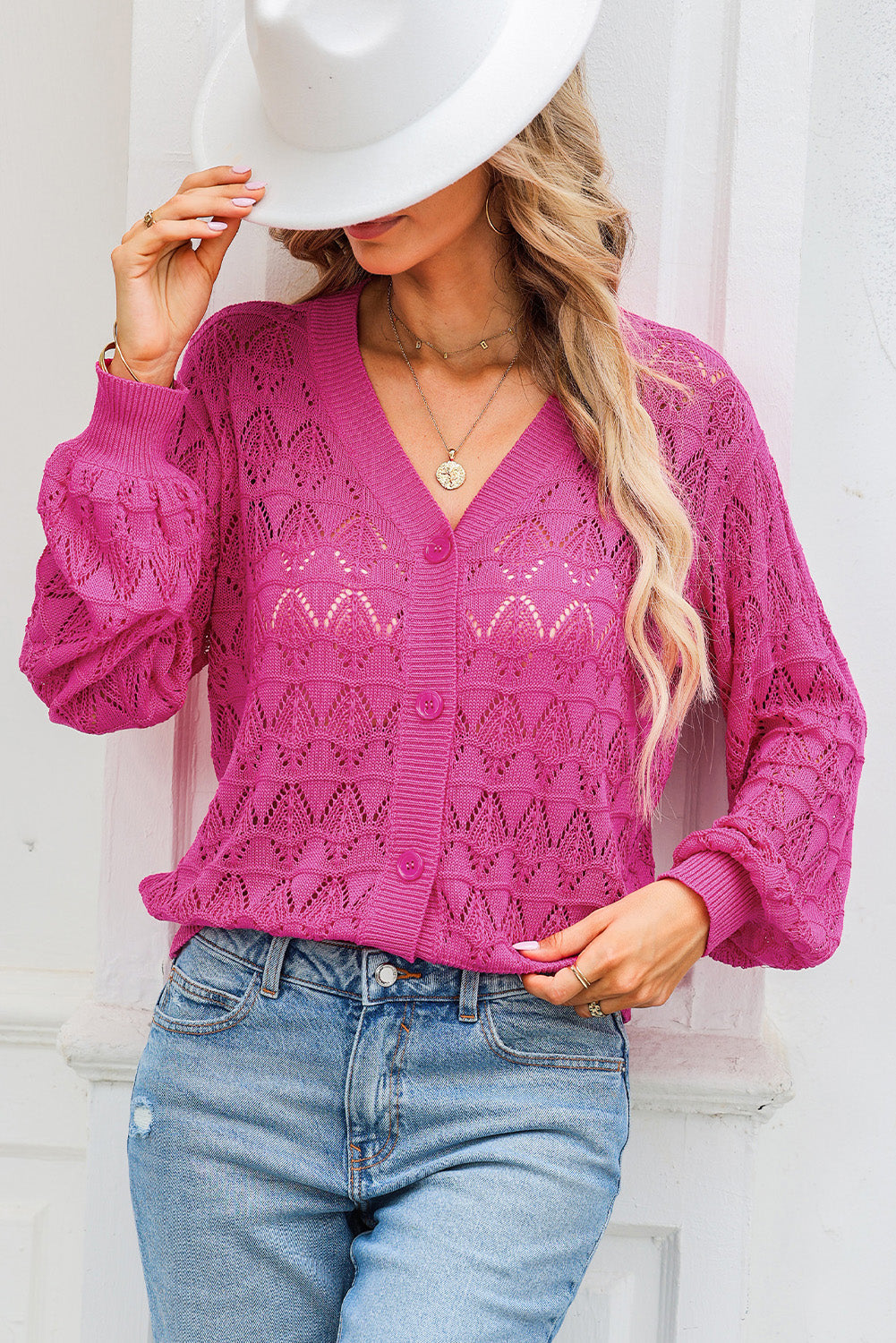 Deep Rose openwork knit cardigan with balloon sleeves and button front.