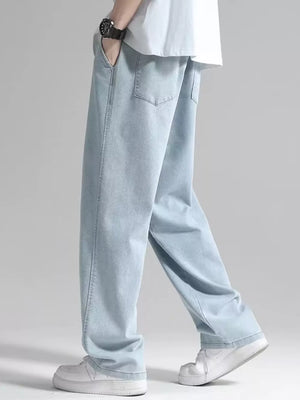 Men's light blue loose fit jeans with drawstring detail and casual styling.
