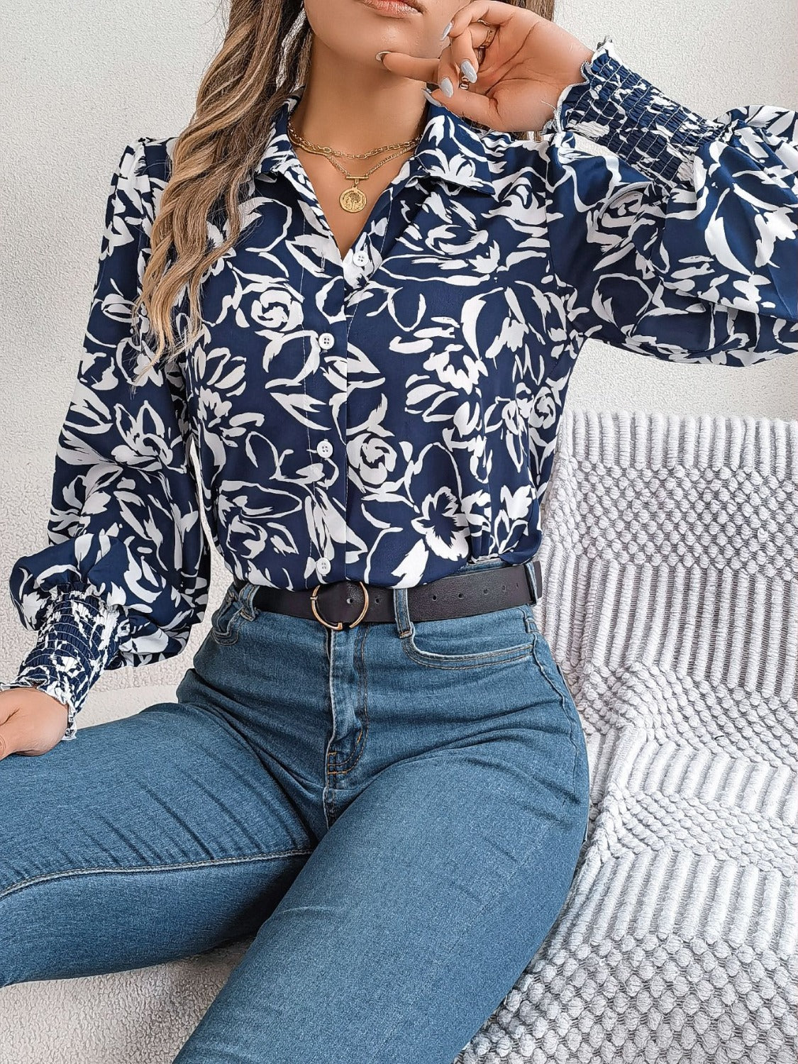 Navy floral print blouse with shirred cuffs and button front