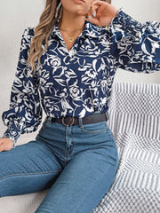 Navy floral print blouse with shirred cuffs and button front