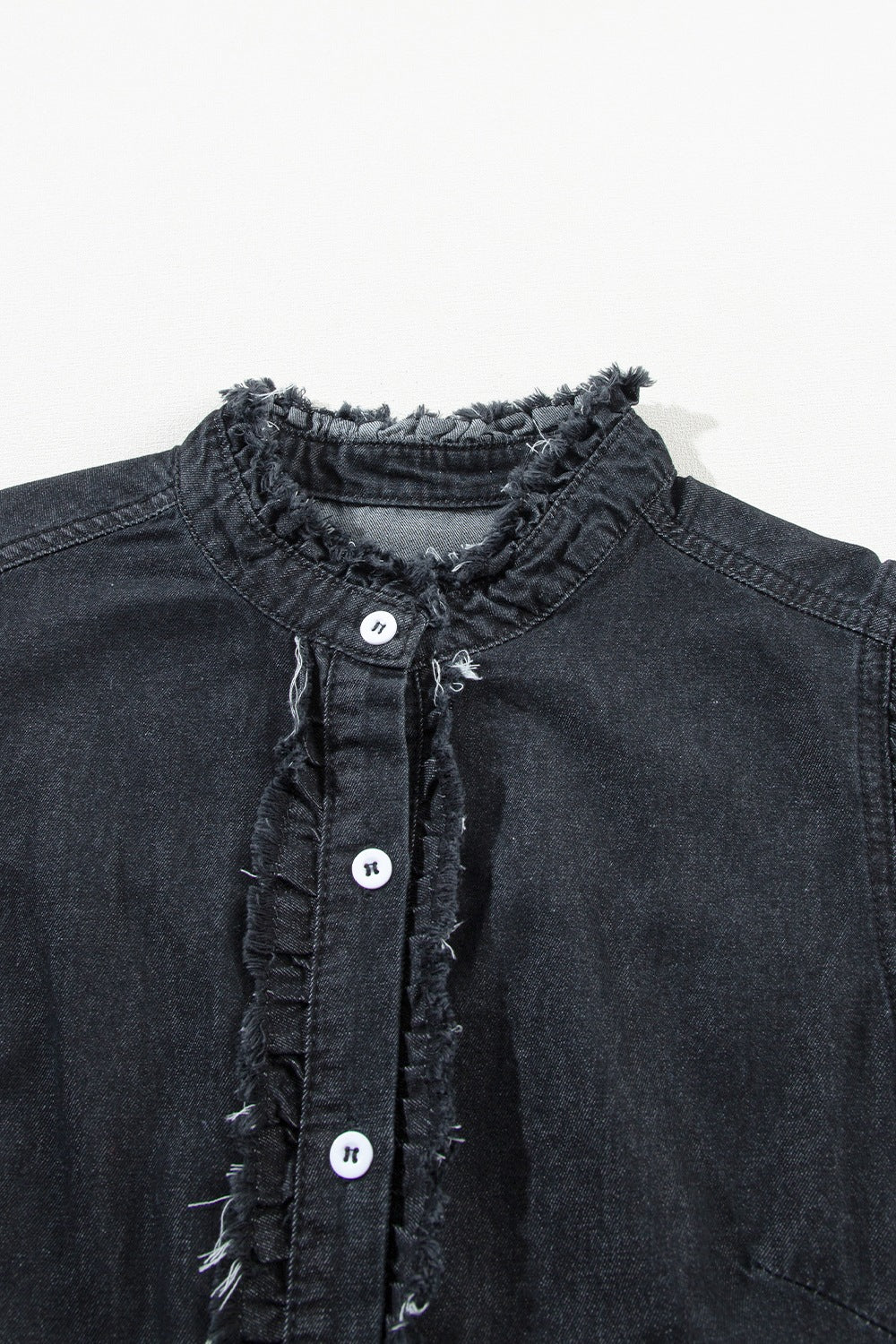 Black denim button-up shirt with frayed ruffle trim and stand collar.