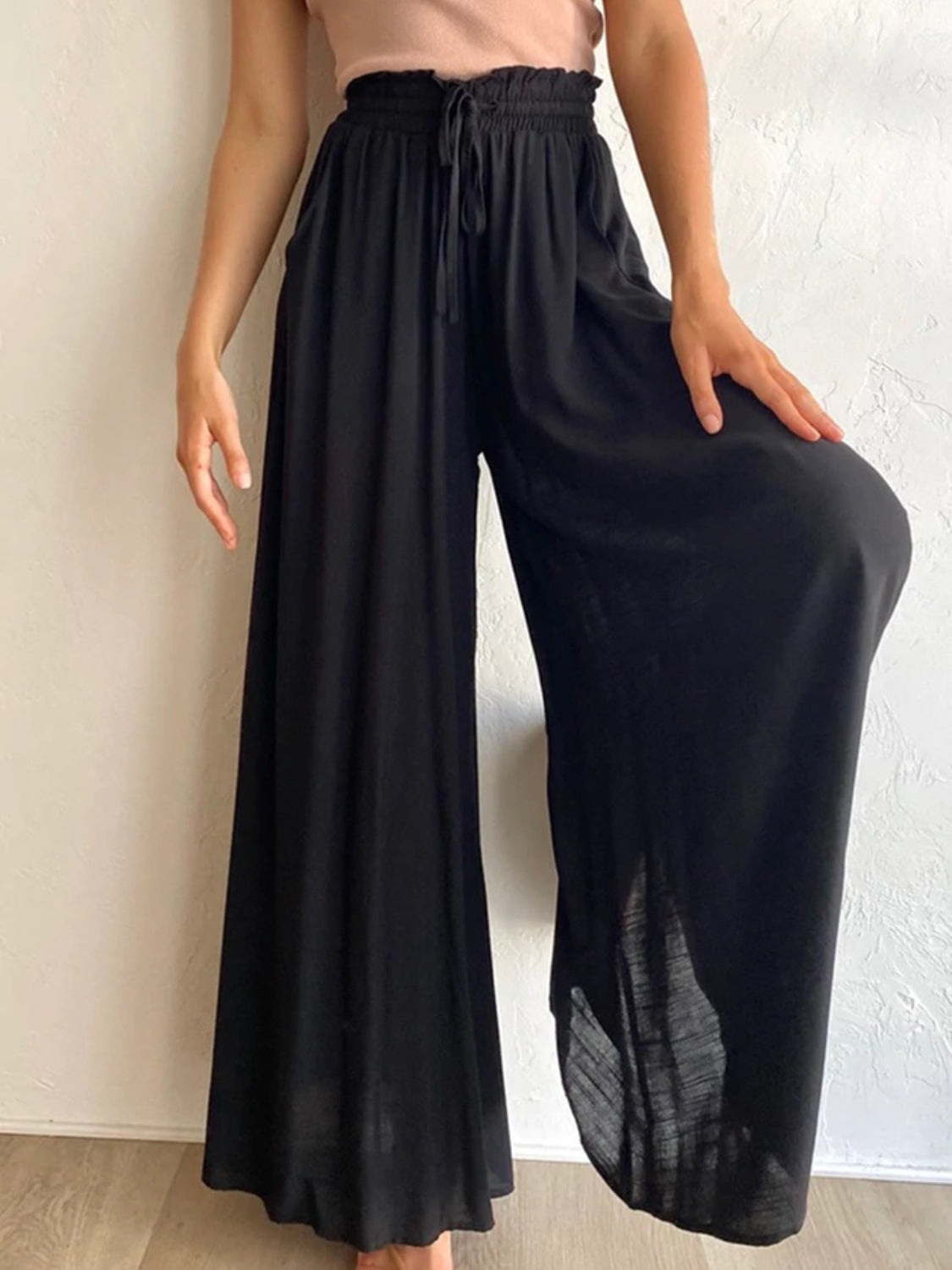 Black gathered waist wide-leg palazzo maternity pants with drawstring.