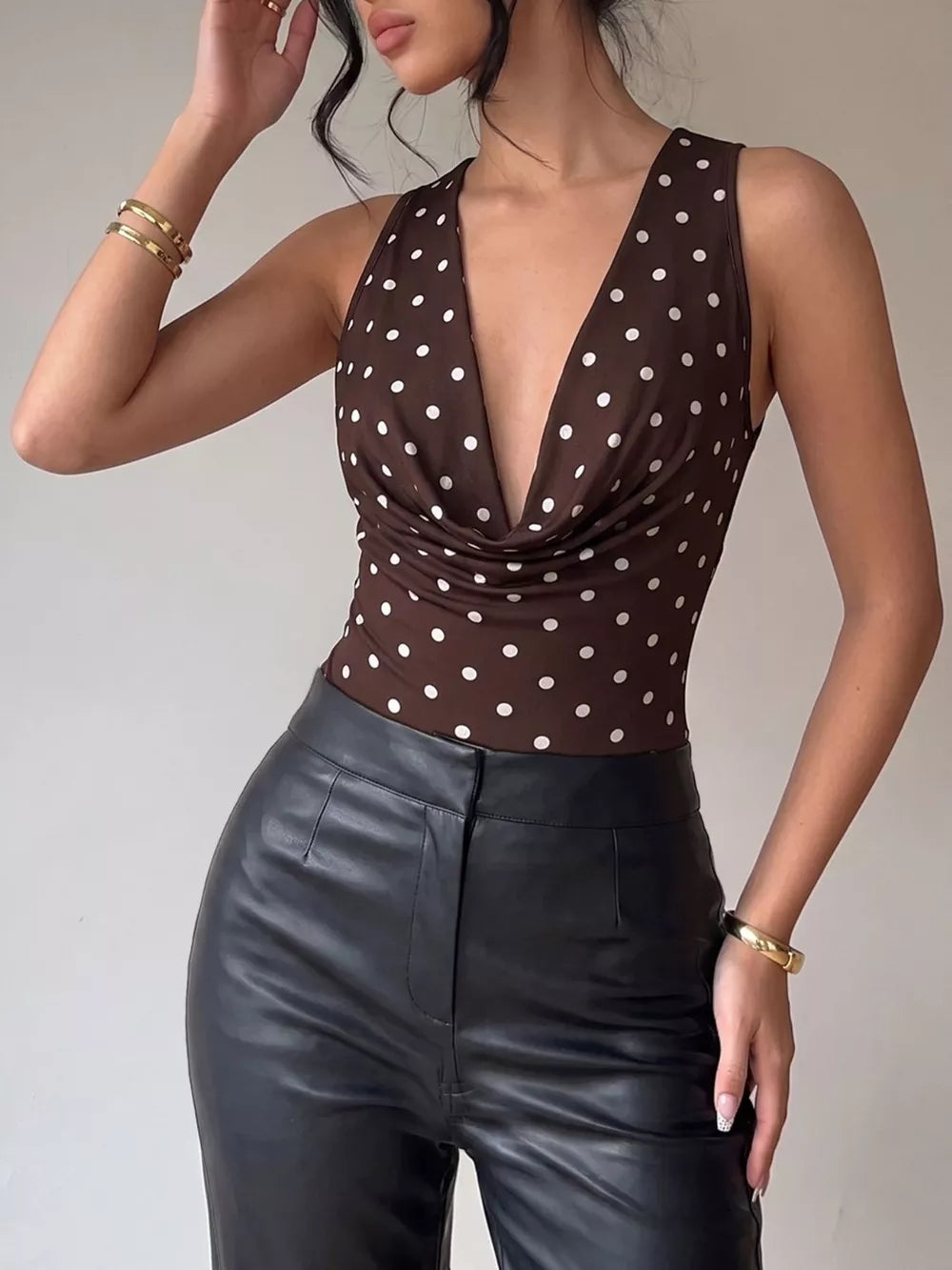 Brown polka dot bodysuit with a cowl neck and deep V-neck.