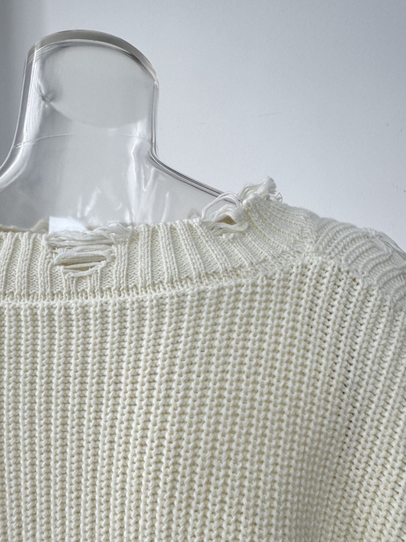 Off white distressed cotton sweater with deconstructed details and frayed neckline.