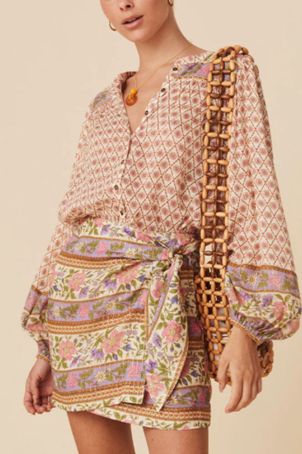 Bohemian print blouson sleeve top with button front and floral pattern.