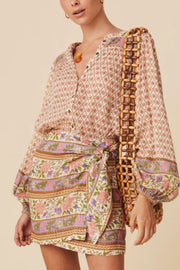 Bohemian print blouson sleeve top with button front and floral pattern.