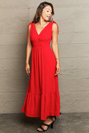 Red polyester midi dress with tie straps, empire waist, and tiered hem.