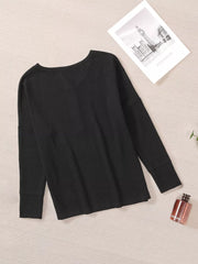 Black textured maternity henley shirt with long sleeves and button detail.