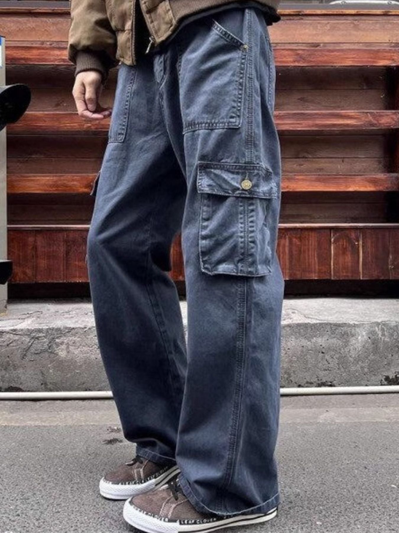Navy blue relaxed fit cargo pants with button-flap side pockets.