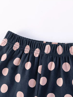 Baby shorts with navy blue and pink polka dots and elastic waistband.