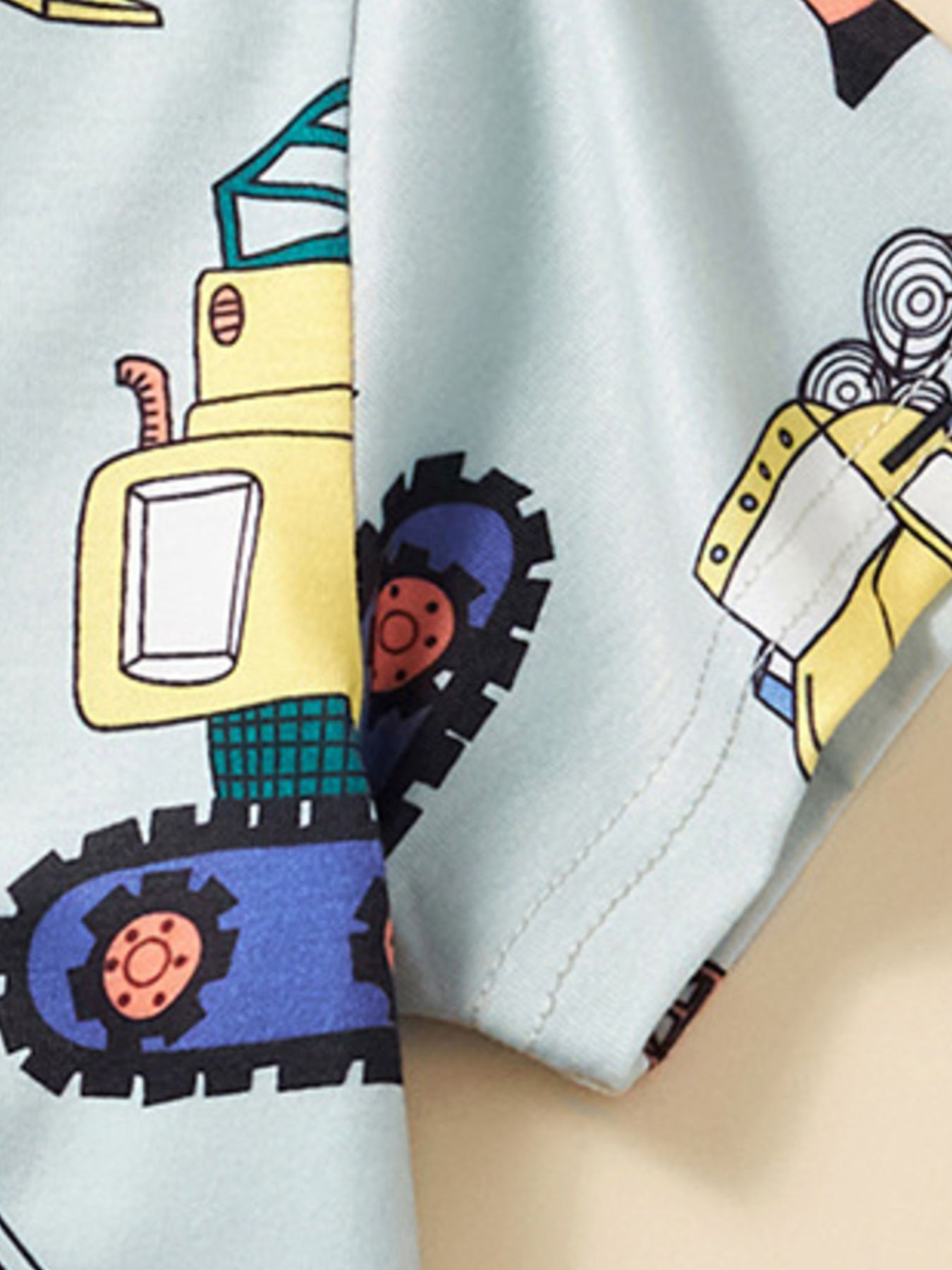 Toddler t-shirt with construction vehicle print in blue, yellow, and black.