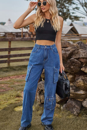 Relaxed wide leg denim cargo pants in medium wash blue with multiple utility pockets.