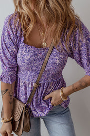 Paisley smocked bodice blouse in lavender with square neckline and ruffled sleeves.