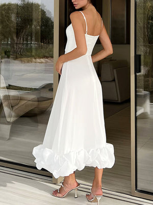 White midi dress with spaghetti straps and a dramatic ruffle hem.