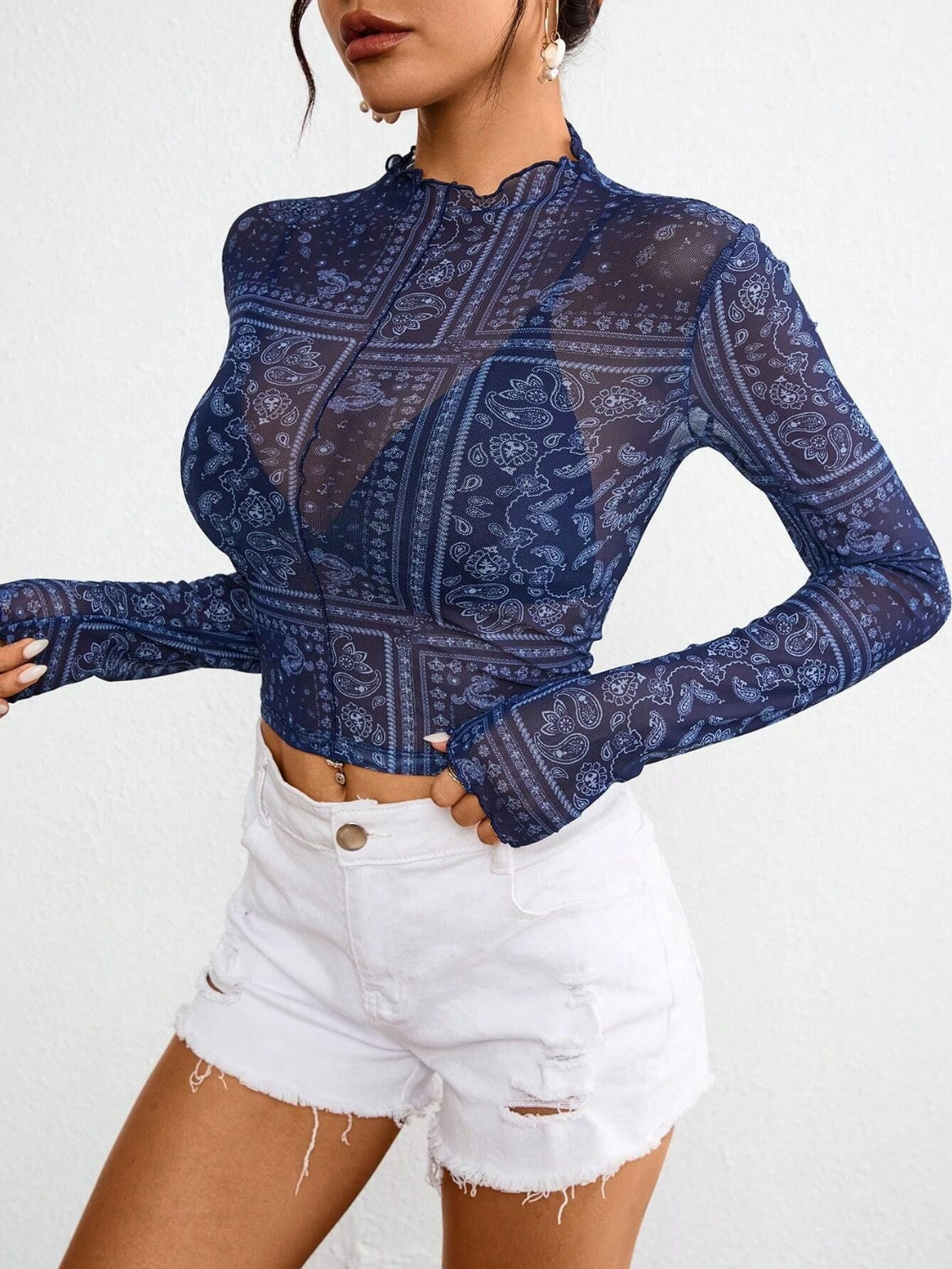 Dark blue bandana print mesh mock neck long sleeve top with lettuce trim.