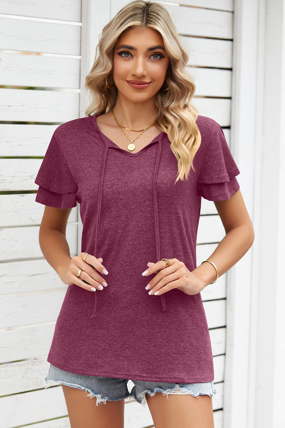 Burgundy flutter sleeve henley tee with tie-neck detail and layered short sleeves.