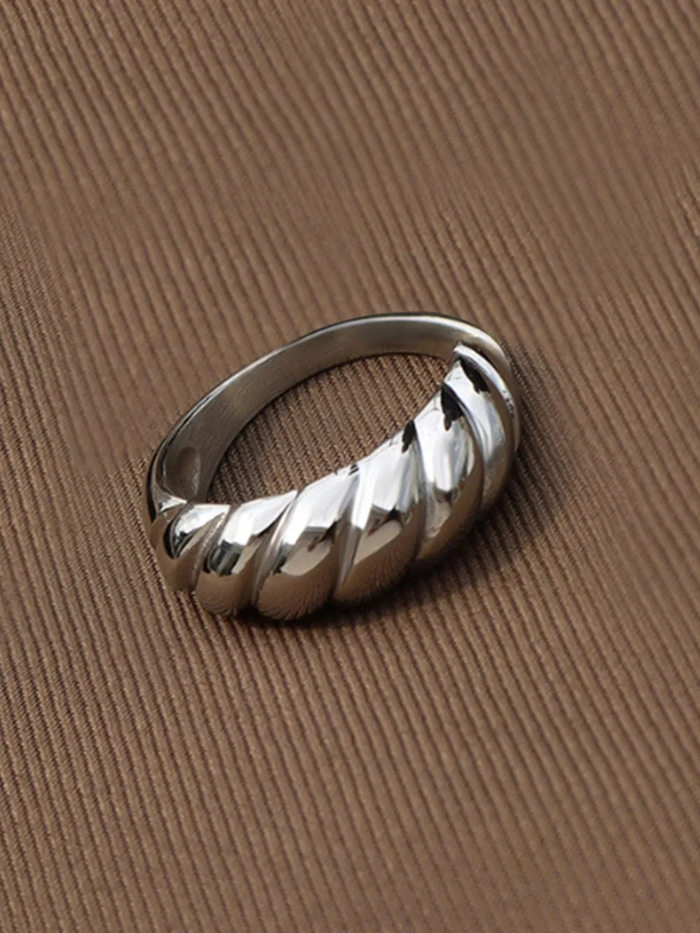 Silver sculpted steel croissant ring with twisted band detail