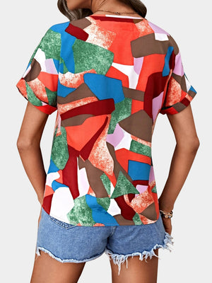 Geometric print V-neck blouse with short sleeves in multicolor abstract pattern.