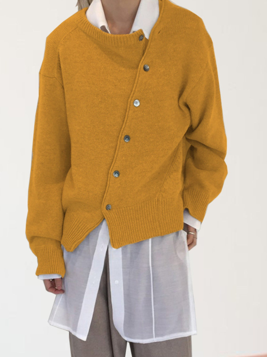 Mustard yellow acrylic knit cardigan with asymmetric button-up front and crew neck.