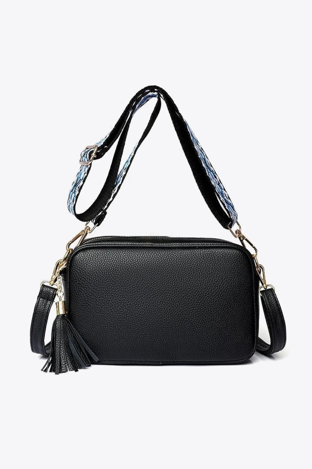 Black textured crossbody bag with tassel detail and patterned strap