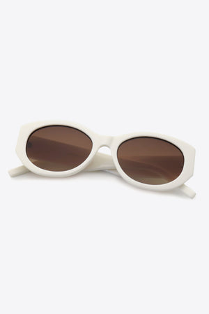 Sculpted oval frame sunglasses in white with brown lenses.