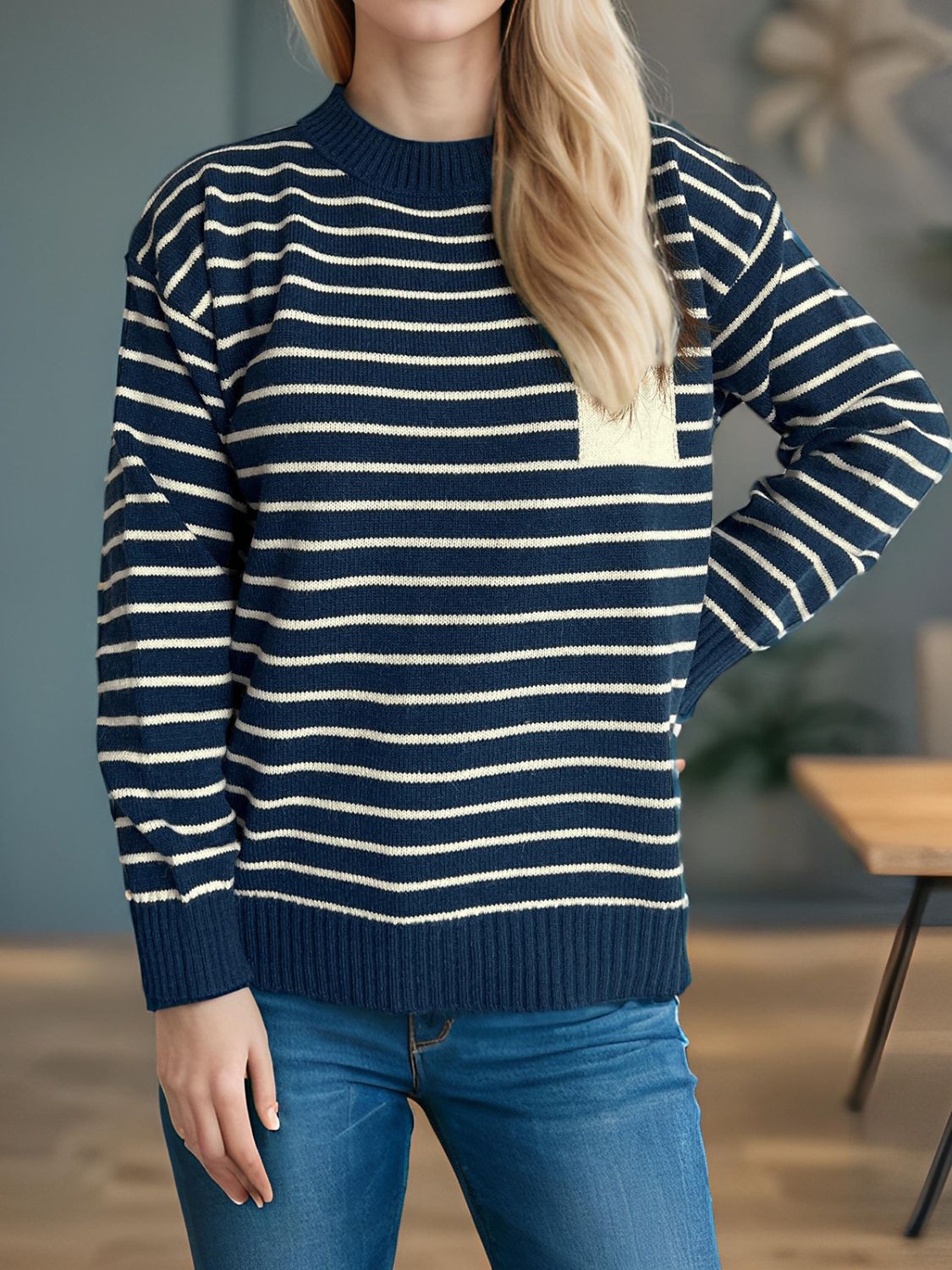Dark blue and cream striped knit sweater with asymmetrical pocket detail.