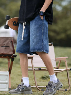 Relaxed fit blue denim shorts with drawstring and pockets.