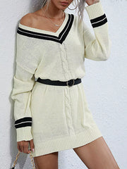 Beige v-neck cable knit sweater dress with black stripe details and a belt.