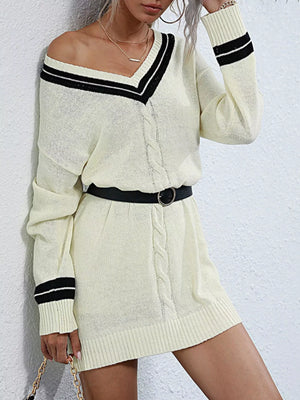 Beige v-neck cable knit sweater dress with black stripe details and a belt.