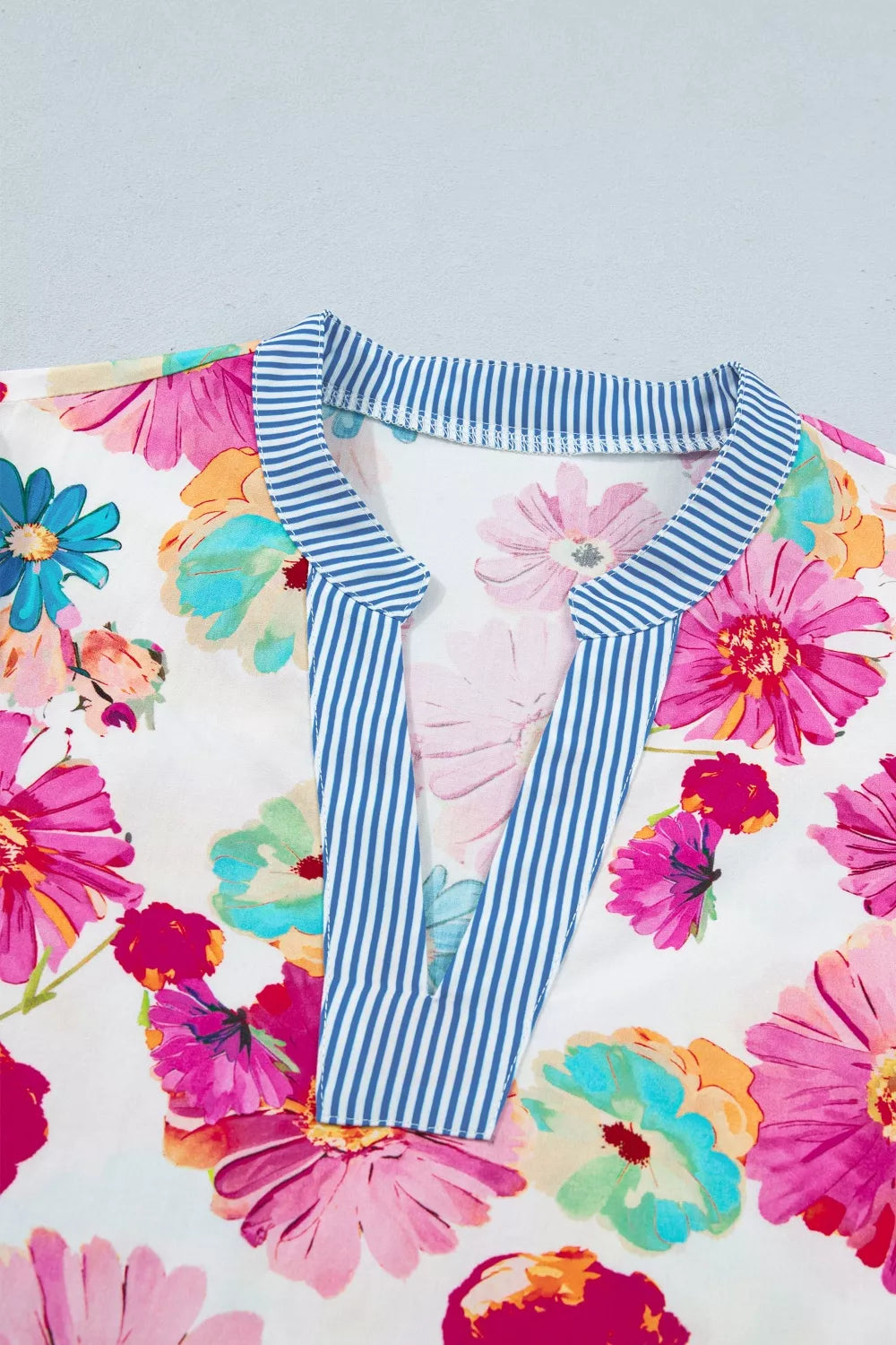 Vibrant floral print V-neck cotton blouse with blue striped trim