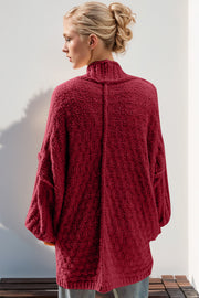 Textured bouclé cocoon cardigan in deep red with balloon sleeves and a mock neck.