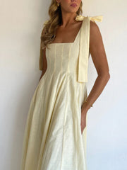 Yellow maxi dress with bow tie shoulder straps and square neckline