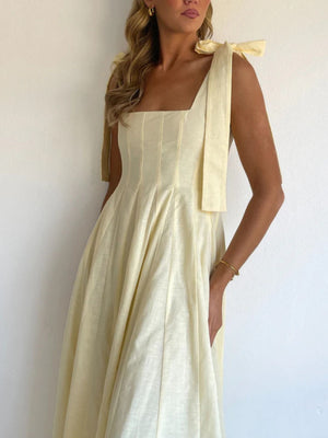 Yellow maxi dress with bow tie shoulder straps and square neckline