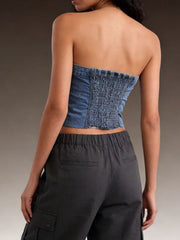 Cropped denim tube top with smocked back detail and raw hem.
