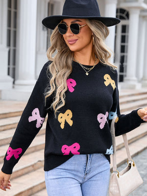 Black knit sweater with colorful bow motif, crew neck, long sleeves.