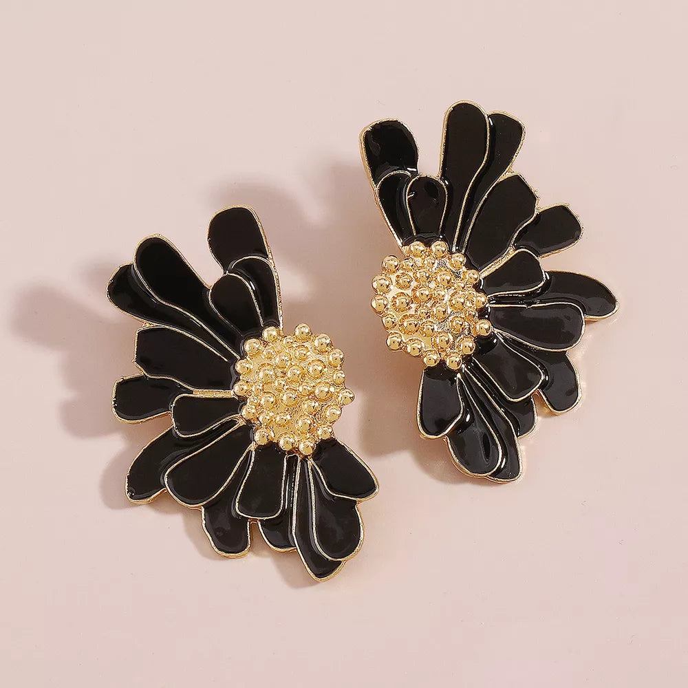 Textured black flower stud earrings with gold beaded centers.