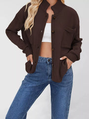 Brown knit cardigan with button-down front and two chest pockets.