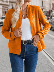 Quilted bomber jacket in Tangerine with zip closure and textured pattern.