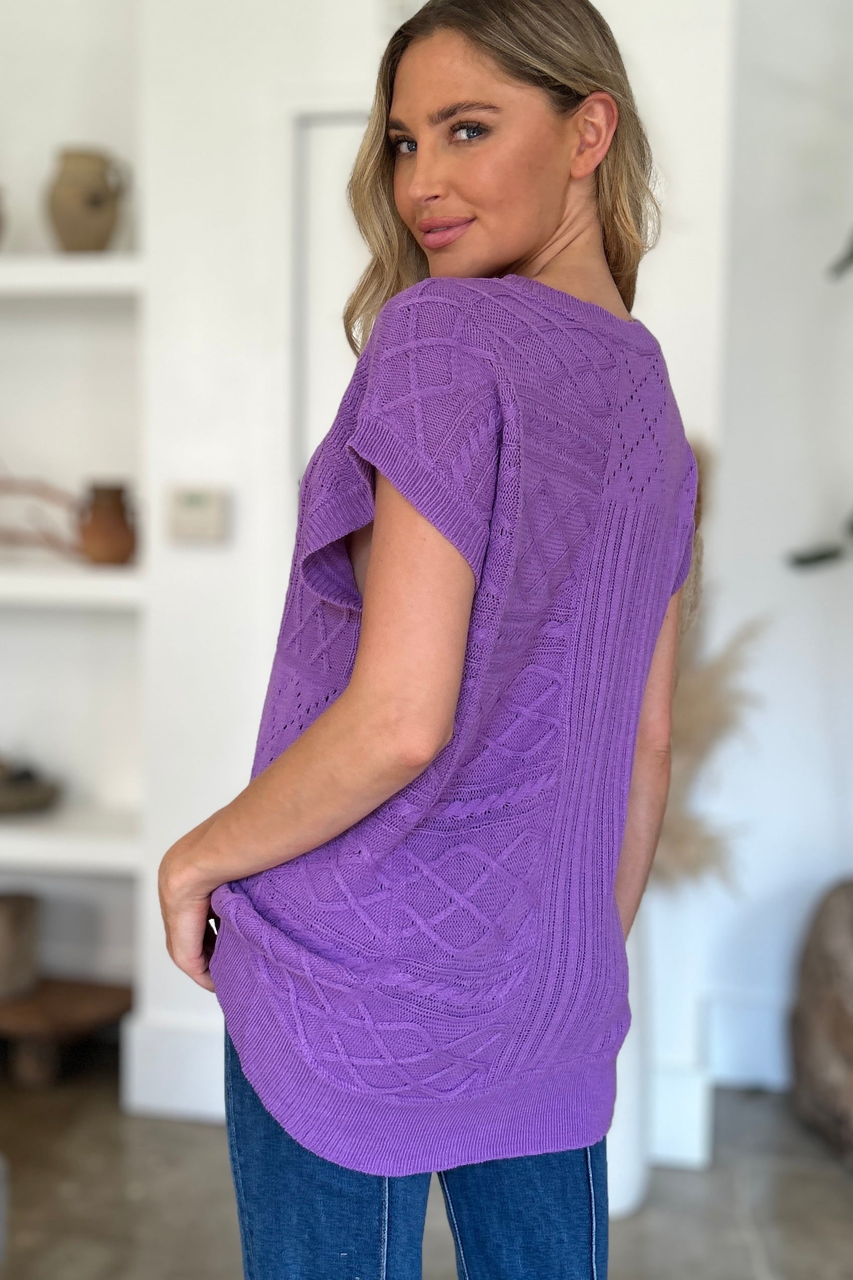 Purple knit patchwork top with short sleeves and a textured cable pattern.