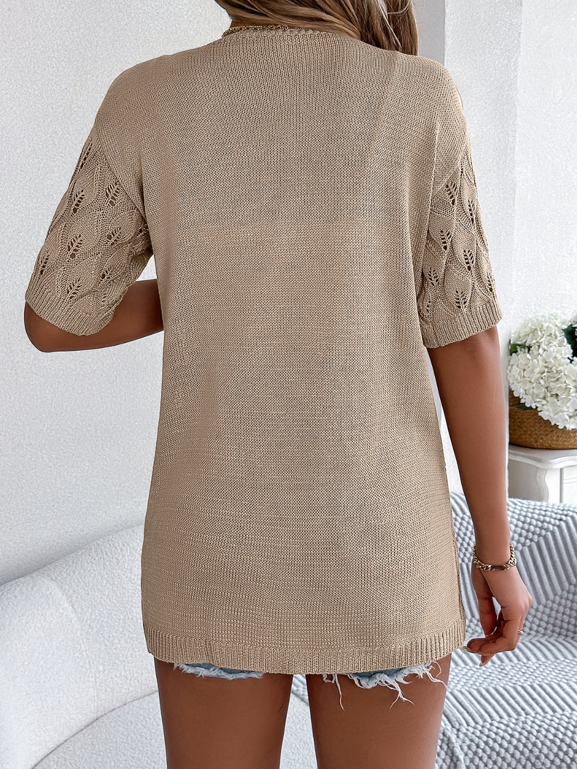 Tan open-knit cardigan with leaf motif sleeves and a crew neck.