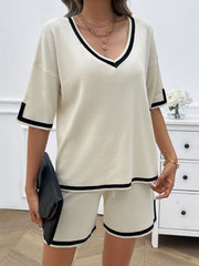 Cream knit lounge set with black contrast trim on v-neck, sleeves, and shorts.