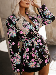 Black floral print wrap blazer with tie waist and long sleeves.