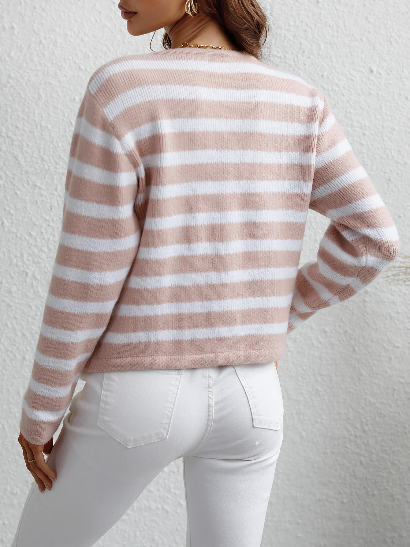 Pink and white horizontal stripe knit cardigan with pockets, crew neck, long sleeves.