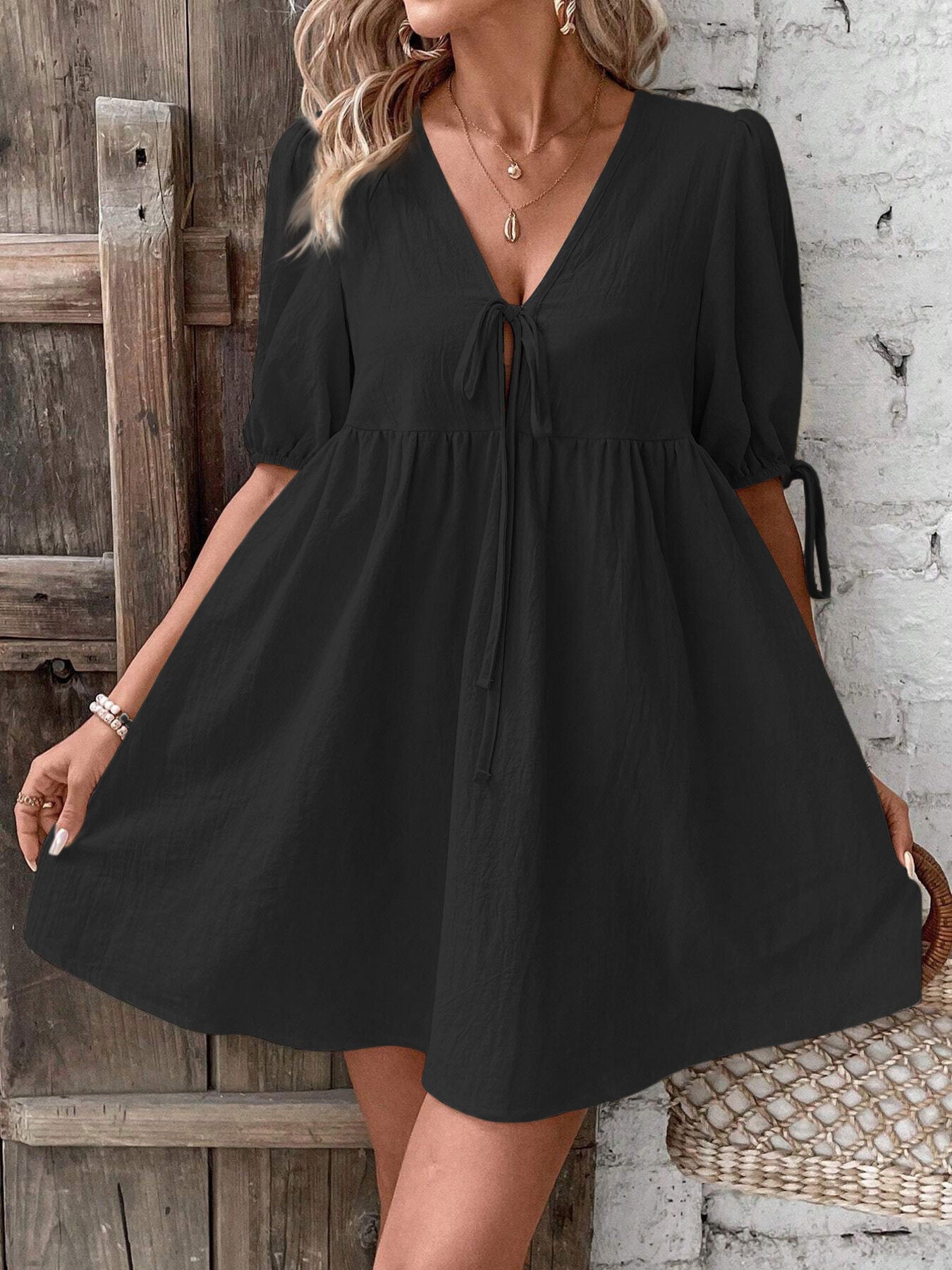 Black tie front puff sleeve mini dress with a-line cut and v-neckline