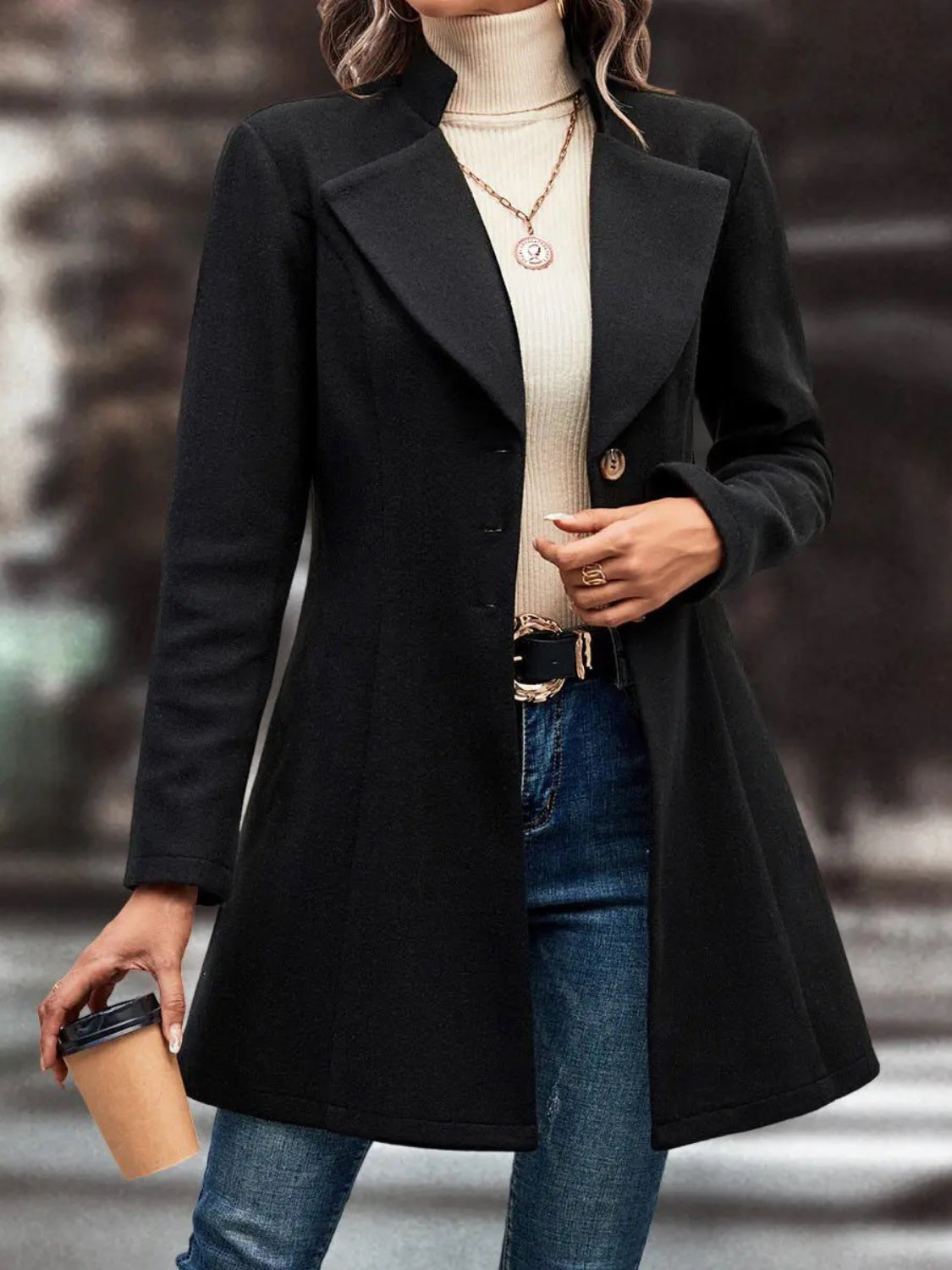 Black wool blend coat with sculpted flare hem and buttoned front.