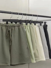 Men's jogger shorts in green, beige, gray, and black with drawstring waist