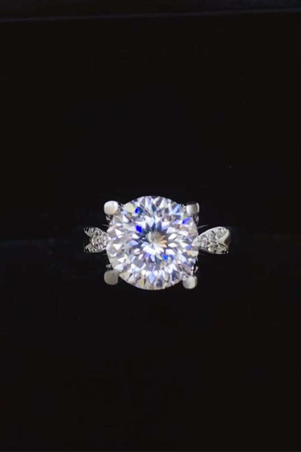 Sterling silver ring with a large round-cut solitaire diamond and a halo of smaller diamonds.