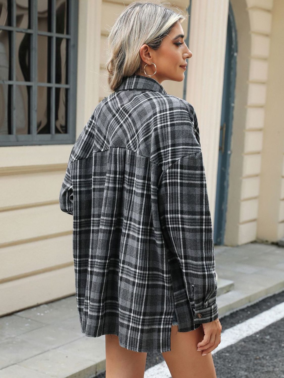 Gray plaid collared long sleeve shirt with button cuffs.
